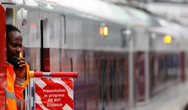 A railway worker in the UK performing his duties (AFP)