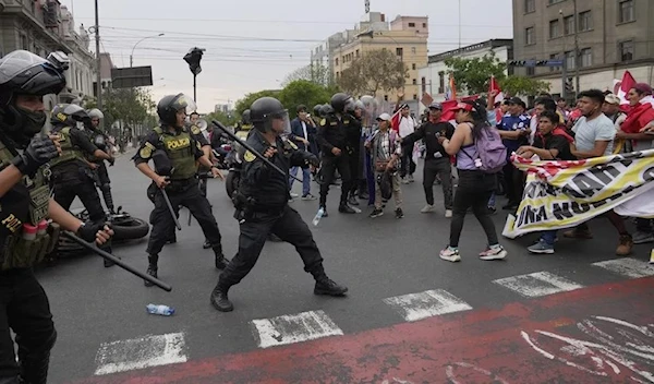 Anti-government protesters who traveled to the capital from across the country march against Peruvian President Dina Boluarte clash with the police in Lima, Peru, January 2023. (AP)