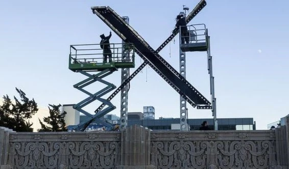 Workers install lighting on an "X" sign atop the downtown San Francisco building that housed what was formally known as Twitter, now rebranded X by owner Elon Musk, on July 28, 2023. (AP Photo)