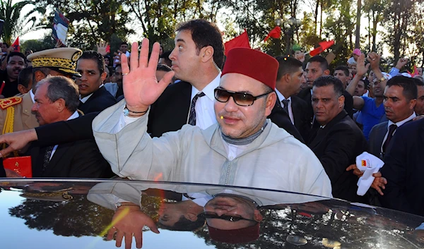 Morocco's King Mohammed VI, waves, upon his arrival at Tunis airport, Friday May 30, 2014. (AP)