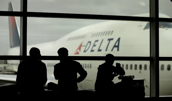 In this Monday, Oct. 29, 2012, file photo, travelers on Delta Air Lines wait for flights, in Detroit. Delta Air Lines Inc. said Thursday, April 14, 2016, it would drop the fee for U.S. consumers who buy tickets over the phone or at a ticket counter. (AP)