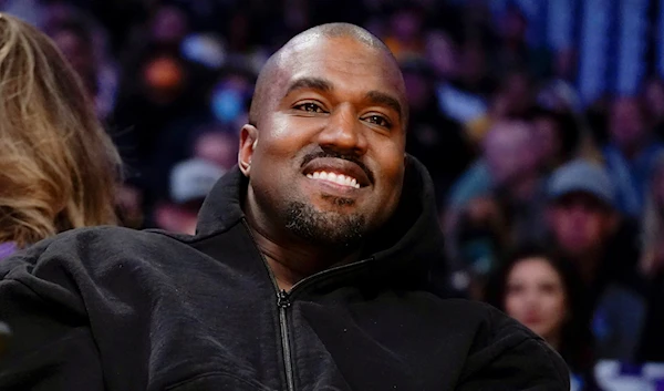 Kanye West, known as Ye, watches the first half of an NBA basketball game between the Washington Wizards and the Los Angeles Lakers in Los Angeles, March 11, 2022. (AP)