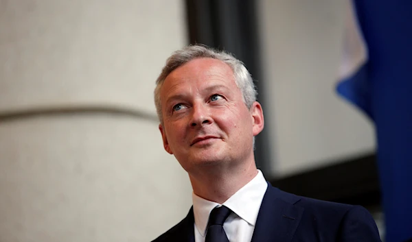 Newly named French economy minister, Bruno Le Maire, 48, left, listens to his predecessor, Michel Sapin, during an handover ceremony in Paris, France, Wednesday, May 17, 2017.