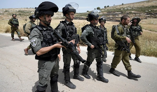 Israeli Occupation Forces are deployed at the site where Israeli settlers burned Palestinian cars and wheat fields in the village of Al-Mughayyir near the West Bank city of Ramallah, Friday, May 26, 2023. (AP)