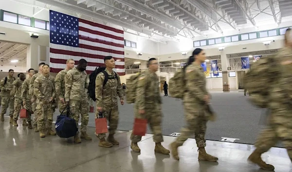 About 130 soldiers with the U.S. Army’s 87th Division Sustainment Support Battalion, 3rd Division Sustainment Brigade, wait to board a chartered plane during their deployment to Europe, March 11, 2022, at Hunter Army Airfield in Savannah, Georgia, US (AP)