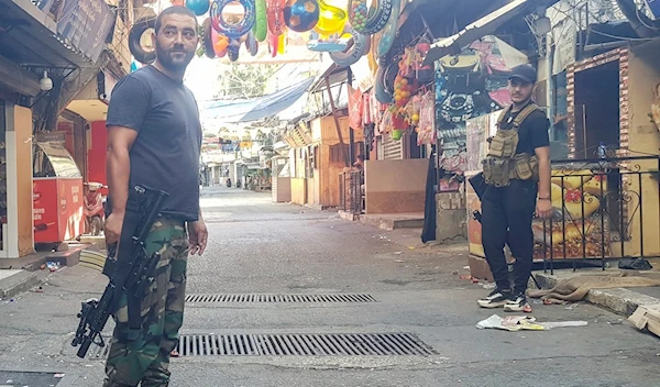 Members of Fatah movement stand guard during a third day of clashes that erupted with Islamist factions in the Palestinian refugee camp of Ain Al-Hilweh camp for Palestinian refugees near Saida, Lebanon, Monday, July 31, 2023. (AP)