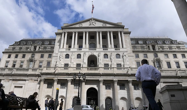 People walk past the Bank of England in London, U.K., May 5, 2022 (AP)