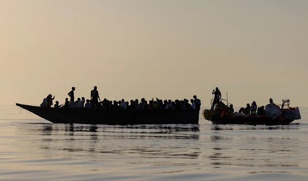 Migrants, left, are being rescued by volunteers of the Ocean Viking, a migrant search and rescue ship run by NGOs SOS Mediterranee and the International Federation of Red Cross (IFCR), Saturday, Aug. 27, 2022. (AP)