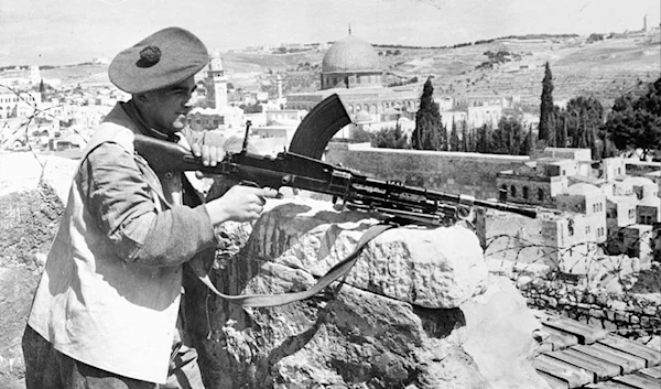 A British soldier aims a machine gun in Al-Quds during the British colonial occupation of Palestine  (AFP)