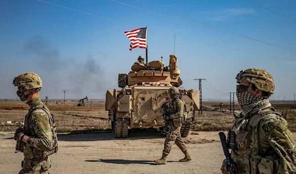 US occupation soldiers patrol by the Suwaydiyah oil fields in Syria's northeastern Hasakah province on February 13, 2021 (AFP)