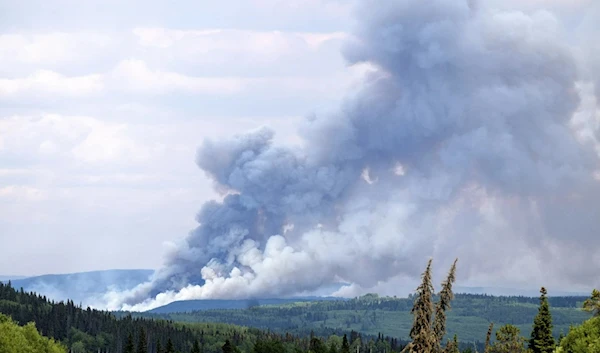 Smoke billows from the Donnie Creek wildfire burning north of Forth St. John, BC, Canada, July 2, 2023. (AP)