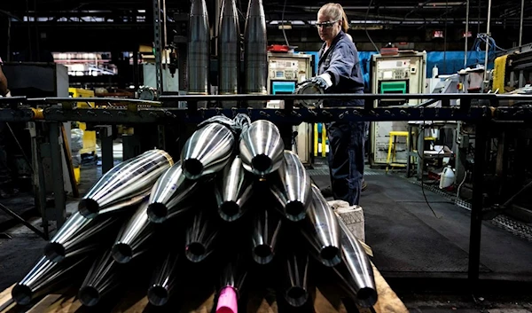 A steel worker moves a 155 mm M795 artillery projectile during the manufacturing process at the Scranton Army Ammunition Plant in Scranton, Pennsylvania , Thursday, April 13, 2023 (AP)