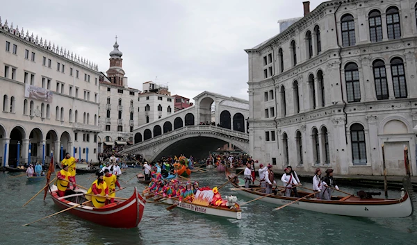 Boats sail during the water parade, part of the Venice Carnival, in Venice, Italy, Sunday, Feb. 5, 2023 (AP)