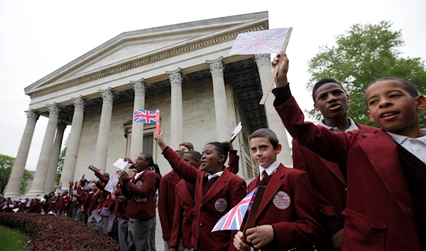 Students wave as Britain's Prince Edward arrives at Girard College, Thursday, April 26, 2012 (AP)