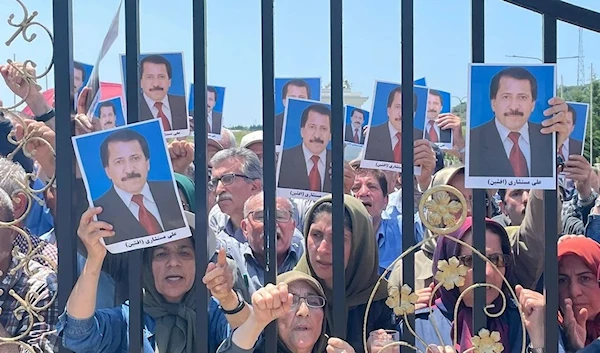 Members of the People’s Mujahedin Organization of Iran (PMOI) protest after Albanian police raided Ashraf 3 camp, June 20, 2023. (AFP)