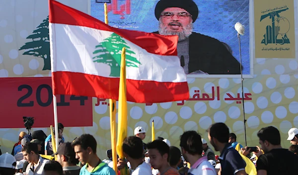 Hezbollah leader Sayyed Hassan Nasrallah delivers a broadcast speech during a rally commemorating Resistance and Liberation Day, Sunday May 25, 2014 (AP)