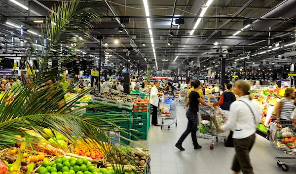 Shoppers stroll the fruits and vegetables area in the new Carrefour store in Ecully, near Lyon, central France, Wednesday August 25, 2010 (AP)