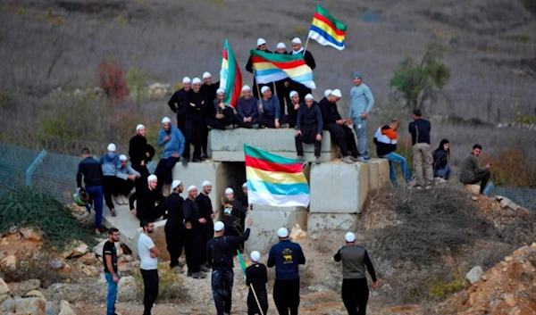 Druze men in occupied Palestine fly their community's flag November 3, 2017 (AFP)