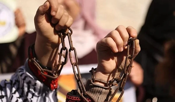 Palestinian women attend a protest in solidarity with female Palestinian prisoners held in Israeli jails, in Gaza city on December 22, 2021. (AFP)