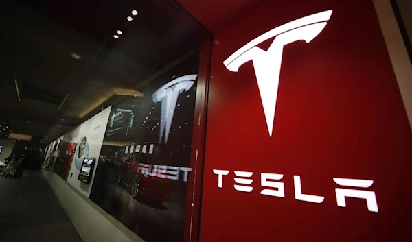 A sign bearing Tesla's logo displayed outside the company's store in Cherry Creek Mall in Denver. (AP)