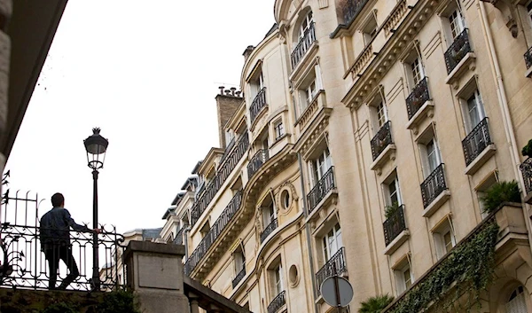 In this Nov.18, 2014 file photo, a man watches Paris buildings in Paris, France. (AFP)