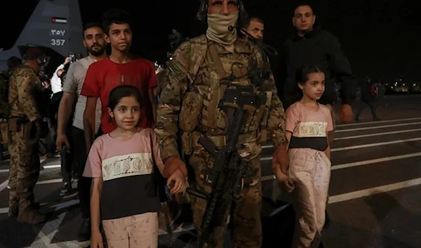 Jordanians evacuated from Sudan arrive at a military airport in Amman, Jordan, on April 24, 2023. (AP)