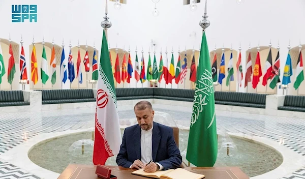 In this handout image released by the state-run Saudi Press Agency, Iranian Foreign Minister Hossein Amirabdollahian signs a register at the Saudi Foreign Ministry in Riyadh, Saudi Arabia, Thursday, Aug. 17, 2023. (AP)