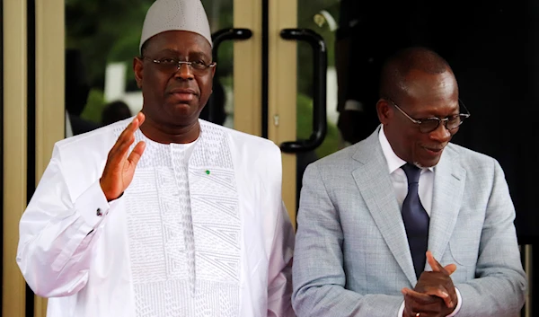 Senegal's President Macky Sall, Left, waves upon arrival for the ECOWAS meeting in Abuja, Nigeria, Thursday, Aug. 10, 2023. (AP)