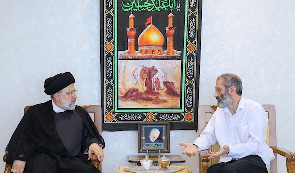 A handout picture provided by the Iranian presidency on August 19, 2023, shows President Ebrahim Raisi (L) meeting in Tehran with Iranian diplomat Asadollah Asadi, who was released in May after being held in Belgium. (AFP)