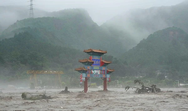 A traditional gate is seen inundated by flood waters in the Miaofengshan area on the outskirts of Beijing, Tuesday, Aug. 1, 2023 (AP Photo/Ng Han Guan)