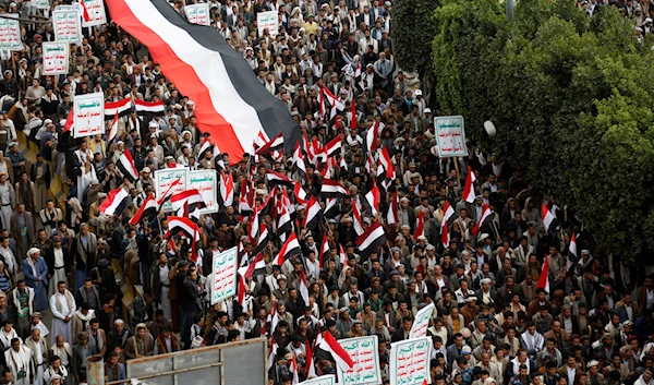 Houthi supporters chant slogans as they attend a rally marking eight years for a Saudi-led coalition, March 26, 2023, in Sanaa, Yemen (AP)