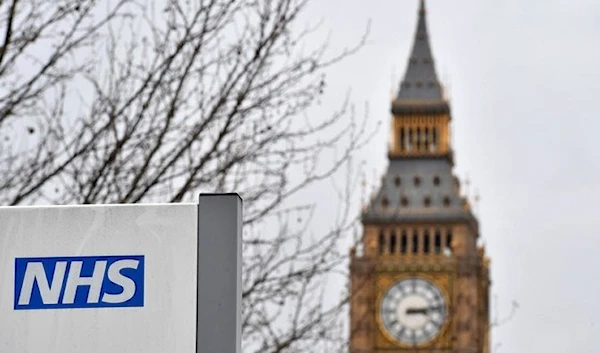 A NHS (National Health Service) sign is pictured outside St Thomas' Hospital, near the Houses of Parliament London on March 8, 2017 (AFP)