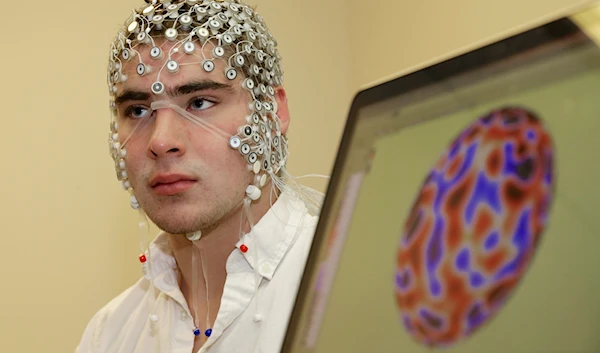 Research assistant Kevin Real wears an EEG net for detecting brain activity which is hooked up to a monitor, at the University of Nebraska's Center for Brain, Biology and Behavior in Lincoln May 31, 2013 (AP)