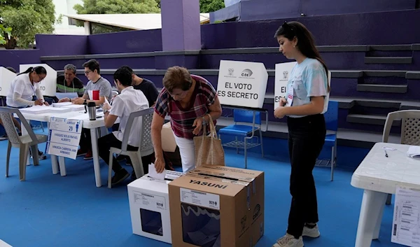 A a voter casts her ballot in a snap presidential election in Guayaquil, Ecuador, Sunday, Aug. 20, 2023 (AP Photo/Martin Mejia)