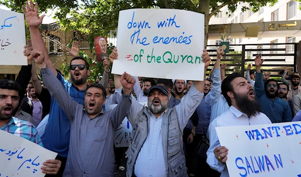 Iranian demonstrators chant slogans during a protest of the burning of a Quran in Sweden, in front of the Swedish Embassy in Tehran, Iran, June 30, 2023 (AP)