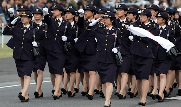 Members of Japan Self-Defense Forces (SDF) march during the Self-Defense Forces Day at Asaka Base in Asaka, north of Tokyo, Sunday, Oct. 14, 2018. (AP)