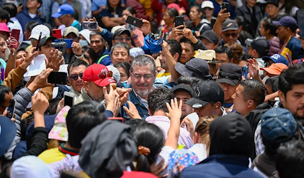 The presidential candidate for the Semilla Movement, Bernardo Arévalo, greets supporters during a campaign event in Totonicapán, Guatemala, on July 15, 2023 (AFP)