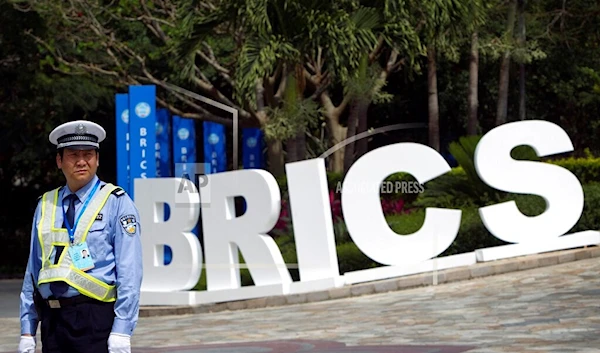 A traffic policeman stands watching outside a venue of BRICS Summit in Sanya, China Wednesday, April 13, 2011 (AP)