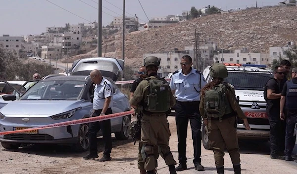 Israeli occupation forces are seen at the scene of a shooting operation near the occupied West Bank city of al-Quds, on August 21, 2023. (AP)