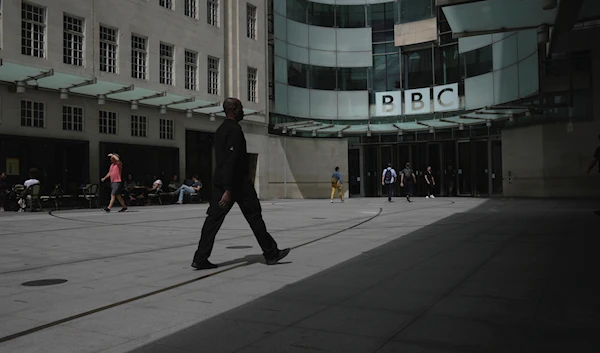 People walk outside the BBC Headquarters in London, Britain, Tuesday, July 11, 2023 (AP)