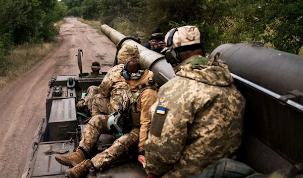 Ukrainian artillerymen sit on a self-propelled cannon near the front line in the Kherson region. (AFP)