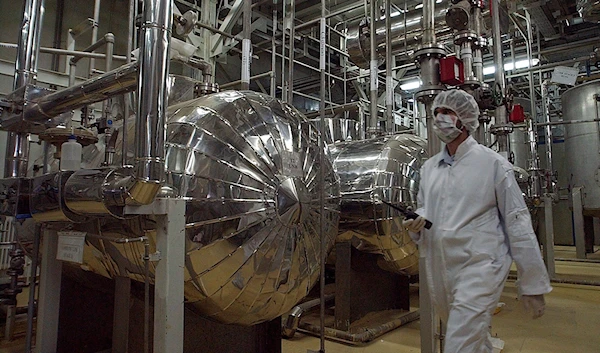 In this March 30, 2005 file photo, an Iranian security official in protective clothing walks through part of the Uranium Conversion Facility just outside the Iranian city of Isfahan. (AP)