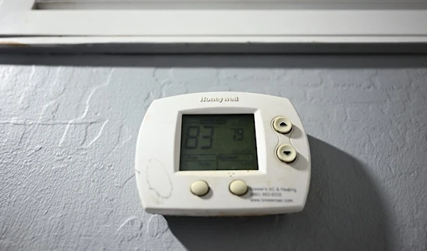 A Honeywell air conditioning thermostat is seen in a house during a record heat wave in Phoenix, Arizona on July 19, 2023 (AFP)