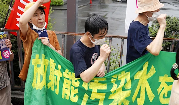 Protesters chant in the rain during a rally against the treated radioactive water release from the damaged Fukushima nuclear power plant, in front of the Prime Minister's office Tuesday, Aug. 22, 2023, in Tokyo. (AP)