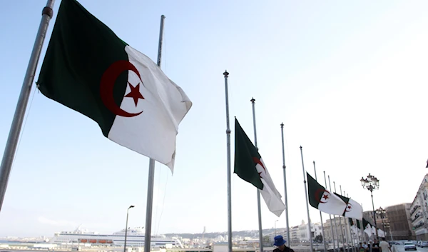 Algerian flags fly at half-staff along the seaside walk in Algiers, Saturday, Sept. 18, 2021. (AP)