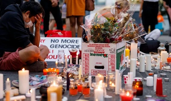 A man holds his head as he attends an impromptu vigil at an anti-Canada Day event titled "No Pride in Genocide" in Toronto in July 2021.  (AFP)