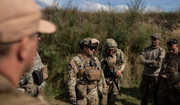 A US volunteer with Ukrainian volunteers after training them in Kiev, August 10, 2023 (AP)