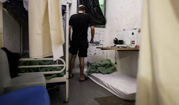 An inmate stands in his two-person cell near a mattress set for a third inmate at Gradignan prison, near Bordeaux, southwestern France, on October 3, 2022. (AFP)