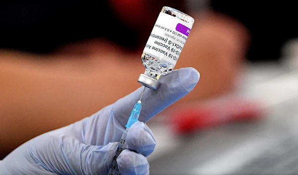 A paramedic prepares doses of AstraZeneca vaccine for patients at a walk-in COVID-19 clinic inside a Buddhist temple in the Smithfield suburb of Sydney on August 4, 2021 (AFP)