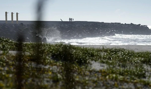 Journalists film the Fukushima Daiichi nuclear power plant from the nearby Ukedo fishing port in Namie town, northeastern Japan, Thursday, August 24, 2023 (AP)